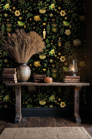 Magical botanical wallpaper with golden accents, styled in rustic dining area with wooden bench and dried pampas grass