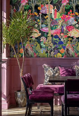 Magical garden wallpaper with exotic flowers and fairy tale figures, shown in sophisticated room with decorative plant