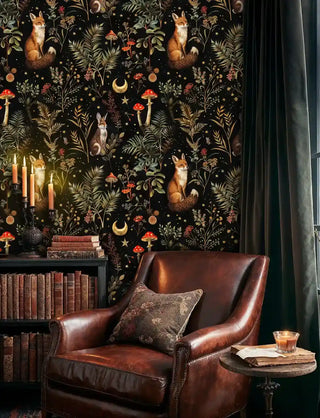 Magical woodland creatures wallpaper with foxes and ferns, shown in study with leather chair and candles