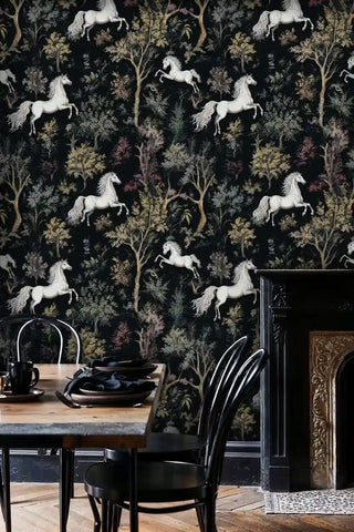 Majestic horse wallpaper with forest motifs in black and gold, shown in dining room with vintage fireplace