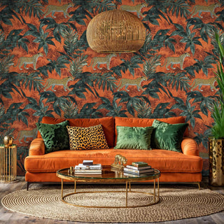 Maximalist leopard wallpaper in rich terracotta and green tones, shown with orange velvet sofa and woven pendant light