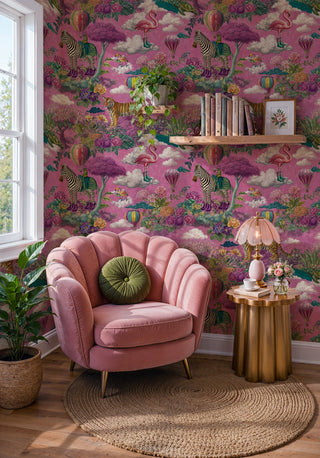 Maximalist pink wallpaper with exotic animals and blooms in a reading nook with pink shell armchair