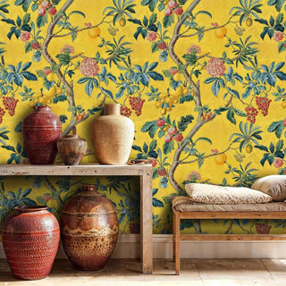 Mediterranean fruit tree wallpaper with golden background, styled with terracotta pottery and woven bench