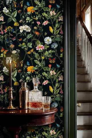 Midnight botanical wallpaper featuring colorful butterflies and blooms, shown in refined hallway with crystal decanter