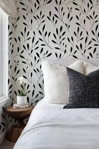 Minimalist leaf pattern wallpaper in serene bedroom with wooden nightstand and orchid plant