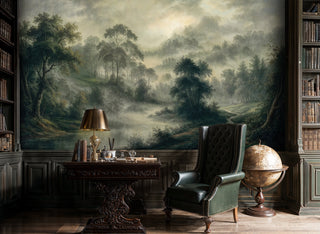 Misty forest landscape wall mural featuring rolling hills and morning fog in green and beige tones, displayed in elegant study with antique globe