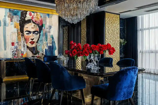 Mixed media portrait wall mural with newspaper collage and floral crown, shown in luxury dining room with crystal chandelier