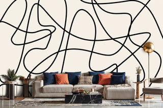 modern abstract wallpaper featuring curved black lines, shown in living room with sectional sofa and marble coffee table