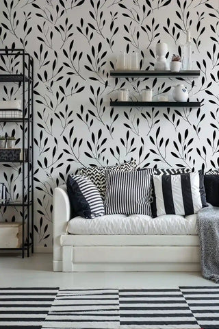 Modern botanical wallpaper featuring flowing branches in living room with geometric striped rug