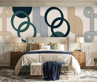 Modern geometric Wall Mural with overlapping circles in navy, green, and gold, shown in elegant bedroom with wood furniture