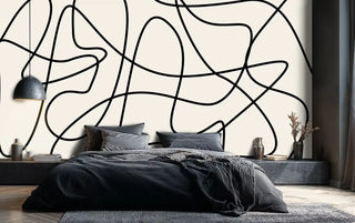 modern line art wallpaper featuring curved black patterns, shown in bedroom with platform bed and pendant lighting