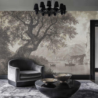 Monochromatic scenic wall mural showing lakeside vista with dramatic cliffs in modern living room with velvet armchair