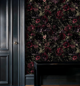 Moody botanical wallpaper featuring roses and ferns, displayed in sophisticated room with dark paneling