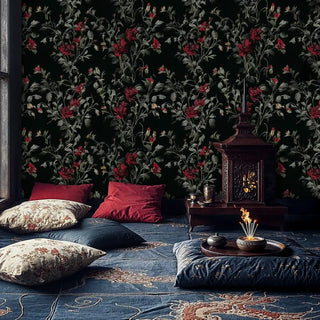 Moody floral wallpaper featuring red blooms in cozy meditation room with floor cushions and lantern