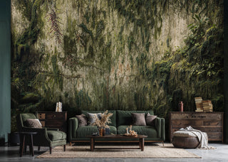 Mossy grotto wall mural with trailing vines and foliage, in a rustic room with green sofa and wooden dressers