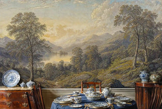 Mountain lake wall mural with pastoral hills and trees in an elegant dining room with blue and white china table setting