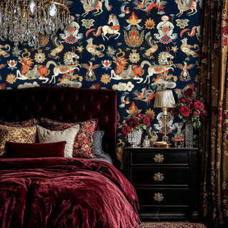 mystical Asian wallpaper with dragons and lotus flowers in navy and gold, displayed in luxurious bedroom with velvet bedding