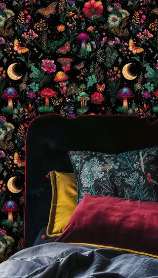Mystical garden wallpaper with butterflies and mushrooms in bedroom with dark velvet headboard and colorful pillows