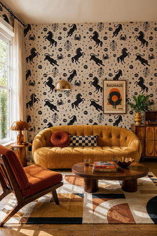 Mystical horse and panther wallpaper on beige, shown in a living room with tufted gold velvet sofa