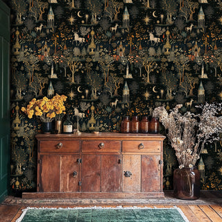 Mystical woodland wallpaper featuring towers and wildlife displayed behind antique wooden sideboard