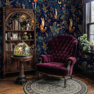 Mystical woodland wallpaper with foxes and celestial motifs displayed in elegant study with burgundy velvet armchair