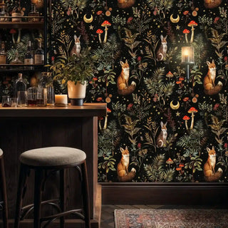 Mystical woodland wallpaper with foxes, rabbits, ferns, and golden stars on black, shown in elegant bar area