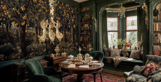 Mythological dancing figures wallpaper with rich botanical details, shown in sophisticated study with built-in bookshelves and round tea table
