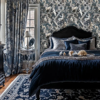 Mythological wallpaper design with unicorns and baroque elements, displayed in luxurious bedroom with navy bedding