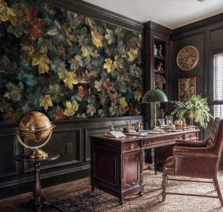 Natural forest wallpaper with autumn leaves in sophisticated home office with antique desk and globe
