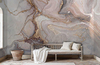 Natural marble wall mural with pink and gold veining displayed in rustic room with weathered wooden bench