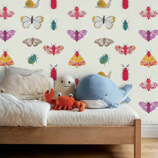 Nature-inspired bug wallpaper with purple moths and snails decorating child's bedroom with stuffed animals