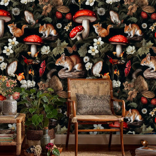 Nature-themed wallpaper with squirrels and botanicals, displayed in bohemian setting with woven chair and plants