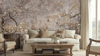 Nature wall mural with delicate blossoms and birds shown in cozy living room with beige sofa and wooden coffee table