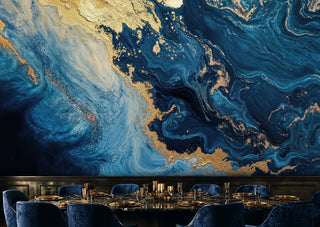 Navy and gold abstract marble wall mural with rich swirling patterns in a formal dining room with gold place settings
