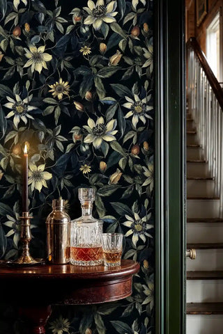 Navy clematis floral wallpaper with cream star-shaped flowers, featured in hallway with crystal decanter set