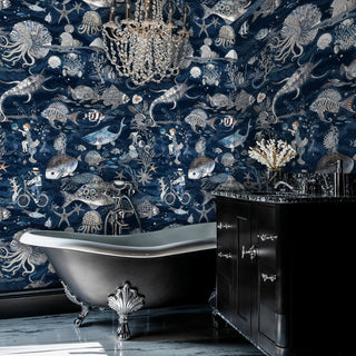 Navy marine life wallpaper with jellyfish and coral, featured in luxurious bathroom with clawfoot tub