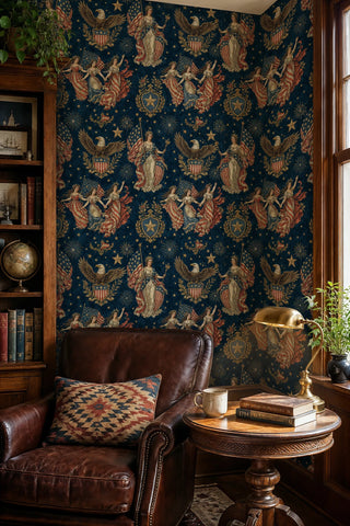 Navy patriotic wallpaper with Liberty figures, flags, and fireworks, displayed in a reading nook with leather armchair and globe