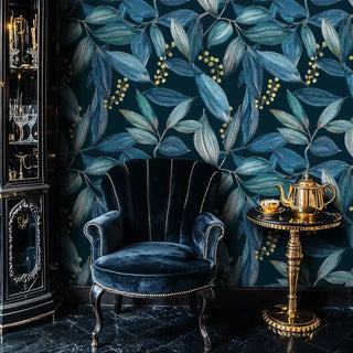 Navy teal botanical leaf wallpaper with gold berries, velvet armchair and tea set