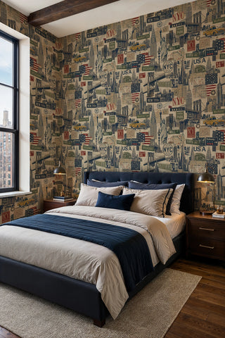 NYC urban collage wallpaper with skyscrapers and signs in a bedroom with navy upholstered bed