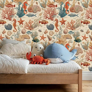 Ocean life wallpaper featuring seahorses, starfish and coral in warm tones, shown in kids bedroom with sea creature toys