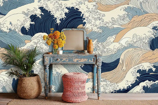 Ocean waves wallpaper with flowing blue patterns, shown in entryway with vintage blue console table and woven ottoman