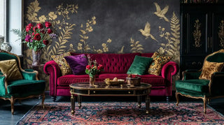 Opulent living room with gilded nature wall mural behind burgundy velvet sofa and emerald armchairs