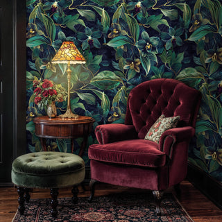 Orchid botanical wallpaper featuring detailed blooms and tropical foliage, in classic study with burgundy armchair