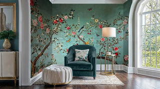 Oriental bird and bloom wall mural in sage and coral, styled in elegant reading nook with teal velvet chair