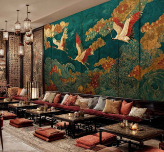 Oriental crane wall mural on teal background in elegant restaurant seating area with low tables