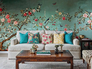 Oriental garden wallpaper with birds and coral flowers, styled in living room with beige sectional sofa