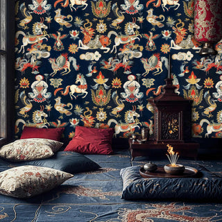 ornate Asian creatures wallpaper featuring mythical beasts, shown in cozy living room with floor cushions