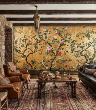 Ornate chinoiserie Wall Mural displaying birds among flowering branches, in rustic living room with stone fireplace
