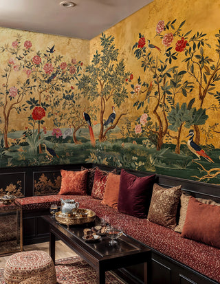 Ornate garden scene wall mural with birds and botanicals, styled in cozy seating area with built-in banquette