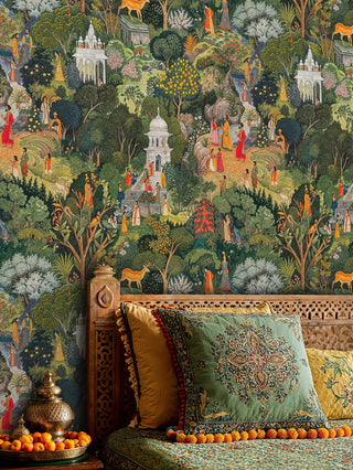 Ornate Indian garden wallpaper featuring temples and wildlife, displayed in a bedroom with carved wooden headboard